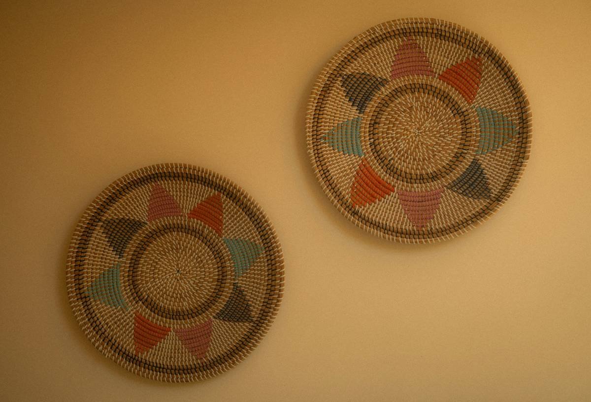 Side-by-side comparison: left shows generic printed mandala art in a boho room that feels disjointed; right shows hand-textured abstract painting with organic shapes that harmonizes with rattan furniture and layered textiles